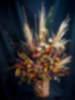 Tall arrangement of assorted dried florals and pampas grasses.