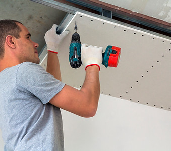 construction-worker-assemble-suspended-ceiling-with-drywall-fixing-drywall-ceiling-metal-f