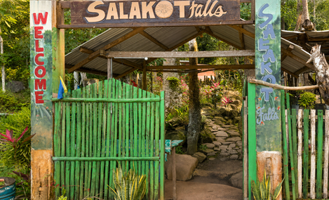 Rustic entrance to Salakot Falls surrounded by tropical vegetation near Puerto Princesa, Palawan