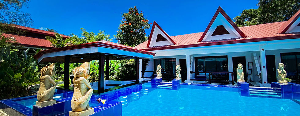 Sunny view of the main pool at Carpe Diem Villas & Resort, featuring a popular swim-up bar for cocktails and service.