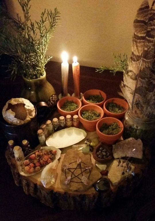 Herbs, Oils and Candles Sitting on an Altar