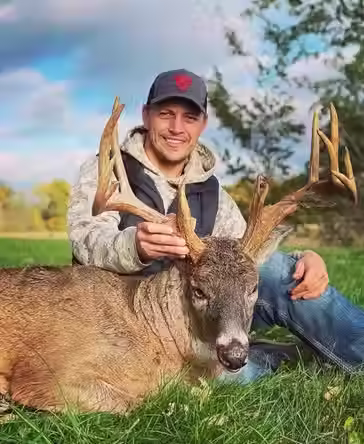 Hunter Showing His Trophy Buck After a Successful Hunt Using Pop’s Loose Moose Minerals and Attractants