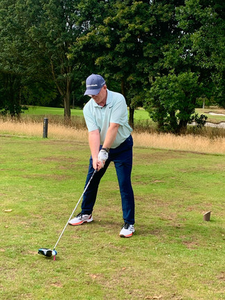 Golf player ready to tee off on a golf course 