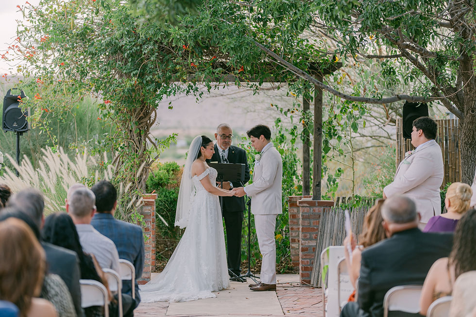 Bride and groom holding hands at the altar during an outdoor ceremony at Ardovino's Desert Crossing, captured by El Paso wedding photographer
