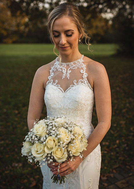 Studio Fifty ThreeWedding flowers at Stirrups Hotel Bracknell Berkshire. A bride with a bouquet of white roses and gypsophila