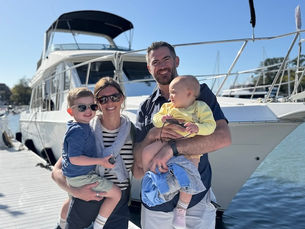 Mather's Family in front of their boat