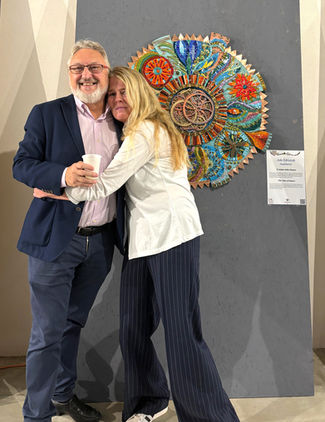 Two artists embracing near julieedmundsmosaics artwork