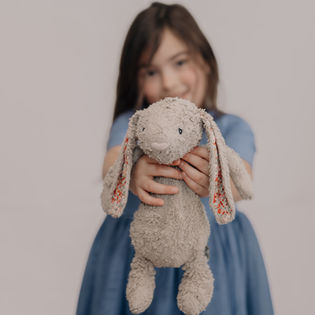 Child holding a well-loved stuffed animal 
