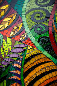 Vibrant mosaic artwork detail: leaves, swirls, and stripes in jewel tones