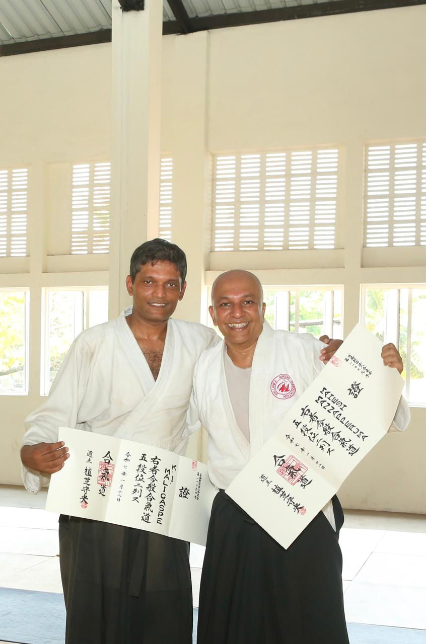 Indika Maligaspe and Mahesh Mannapperuma posing with their 5th Dan promotion certificates
