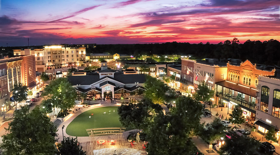 Mobile Notary in The Woodlands, TX showcasing the town center with illuminated storefronts and walkways. Providing professional estate planning and documents signing services.