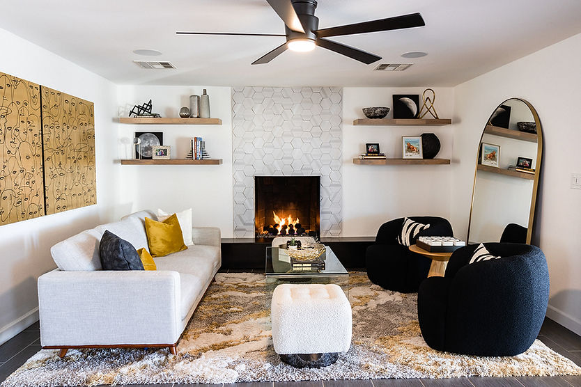 mid century modern living room with fireplace and floating shelves, black white and gold decor