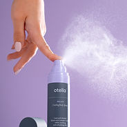 Product photography showing hand and spray mist cooling product; purple backdrop