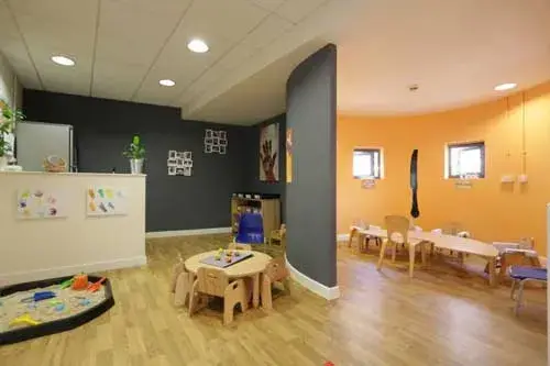 nursery with seating areas and kitchen area