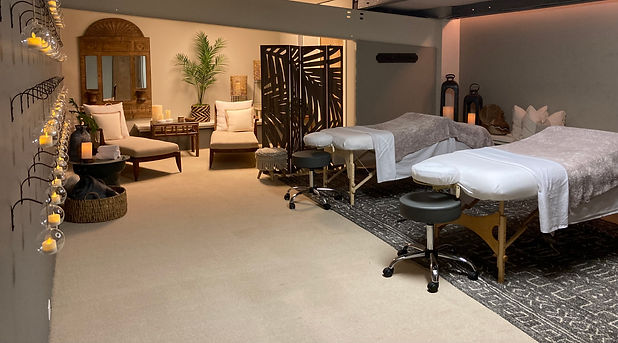 Set up of the couples room (Couples Nest) with cozy candles rolled towels and plush seating