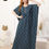 Thumbnail: Woman in teal polka-dot nightdress