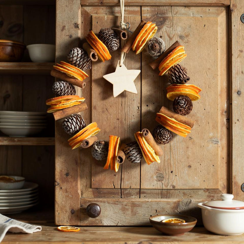 This beautiful Christmas wreath is made from muirii cones, dried orange slices and cinnamon sticks, and scented with the ‘Christmas in a Bottle’ oil. It is finished off with a raffia hanger and a wooden star hanging in the middle.