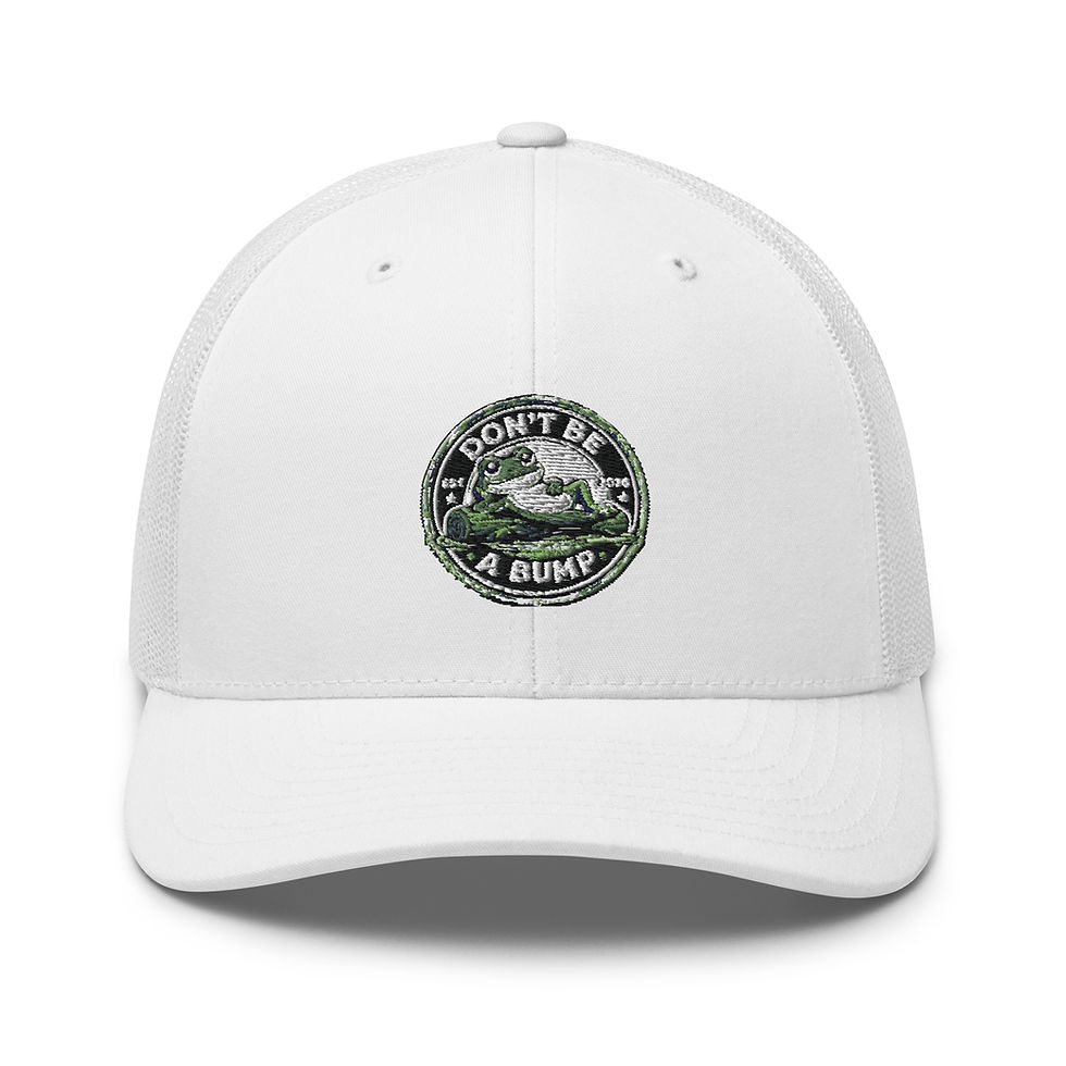 Front view of a white trucker cap with a circular patch showing a cartoon frog and the text 'DON'T BE A BUMP'.