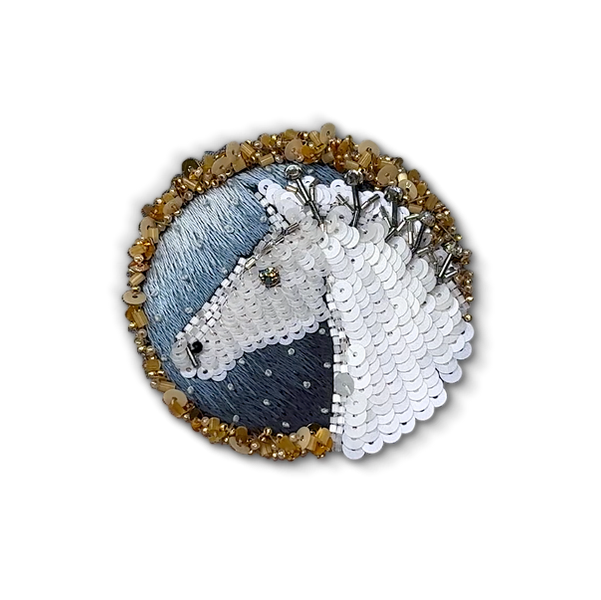 Hand-embroidered horse brooch with white sequins on a blue silk background, framed with gold beads 