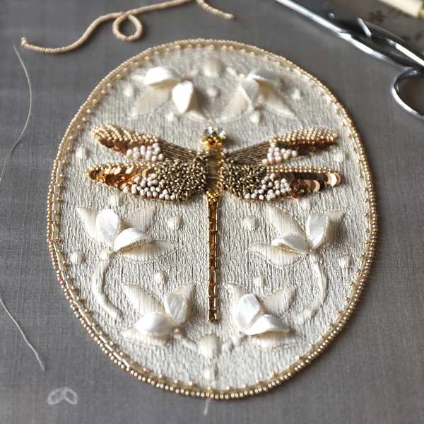 Hand-embroidered dragonfly created with Luneville hook technique using beads, sequins and goldwork e