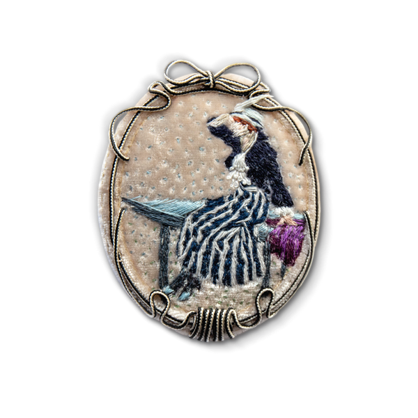 Hand-embroidered brooch inspired by an impressionist painting, featuring a stylized woman on velvet with a decorative soutache frame
