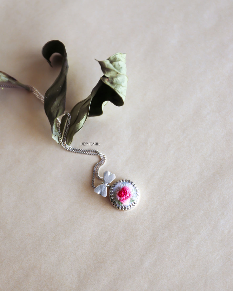 My Odd Pearls Miniature No. 01 "Rose" pendant, a hand-embroidered pink rose in wool thread on a pearl in a silver setting wit