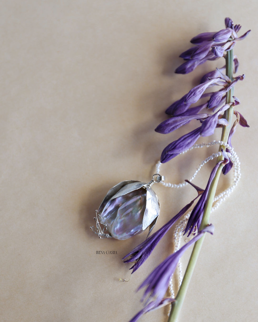 Thumbnail: a baroque pearl with hand-shaped silver petals and stamens, on a fine freshwater pearl strand
