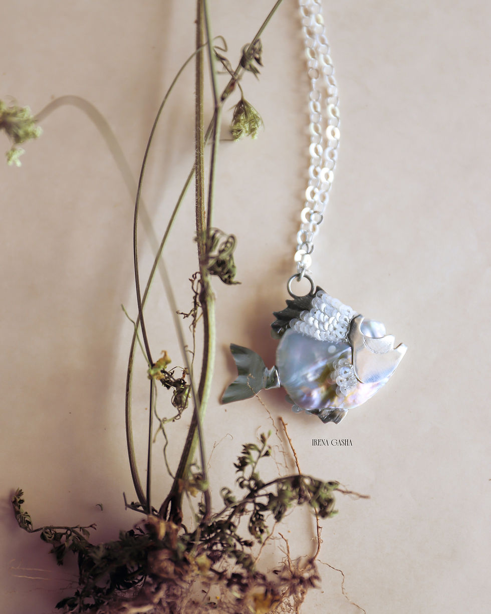 Thumbnail: My Odd Pearls Baroque No. 03 "Catch" fish-shaped pendant with silver fins, tail and sequin embroidery, hanging beside dried r