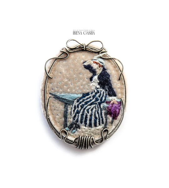 Hand-embroidered brooch inspired by an impressionist painting, featuring a stylized woman on velvet with a decorative soutache frame
