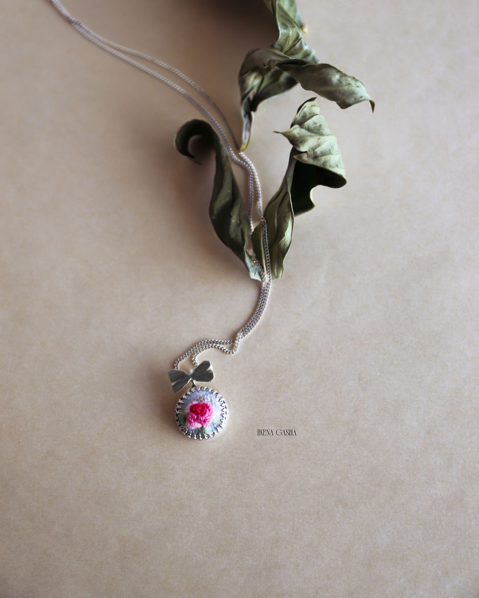 Thumbnail: My Odd Pearls Miniature No. 01 "Rose" pendant, a hand-embroidered pink rose in wool thread on a pearl in a silver setting wit
