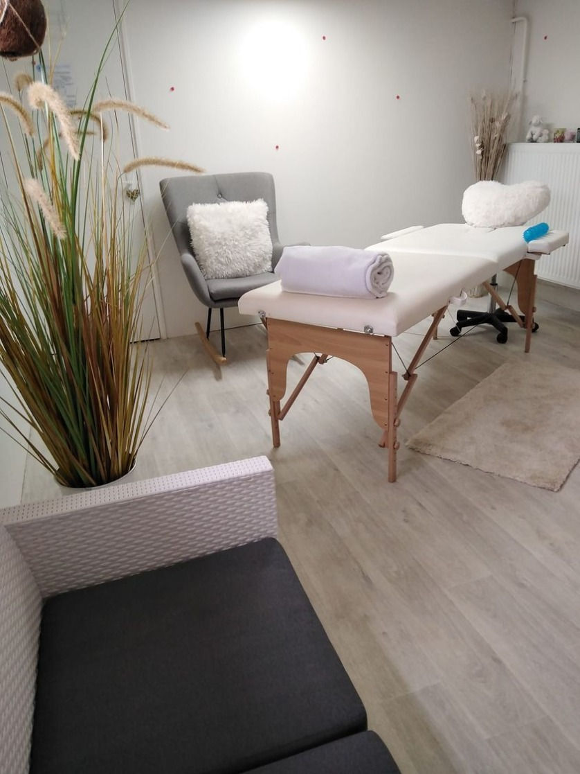 Plan rapproché d’une table de massage avec huiles essentielles et bougies