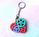 A red, Geen and purple heart shaped cog fidget key ring.