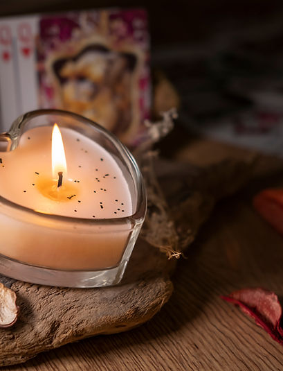 Attributes for love magic and fortune telling on cards, a candle on a wooden background, d