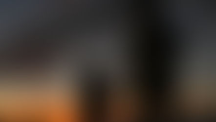 Dad holding daughter's hand on beach at sunset