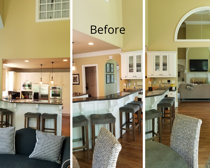A transitional kitchen with Arctic white perimeter cabinets and stained island cabinets. It also features a hidden walk-in pantry and a black metal range hood.