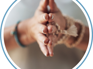 Hands in prayer with mantra beads