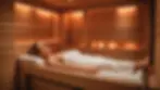 Eye-level view of an infrared sauna session showing a single individual relaxing