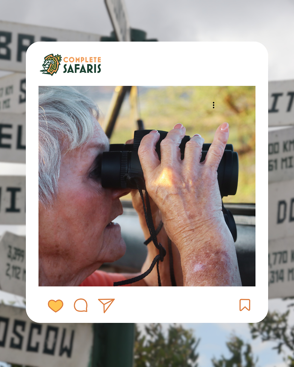 Photo of white haired Complete Safaris client looking through binoculars