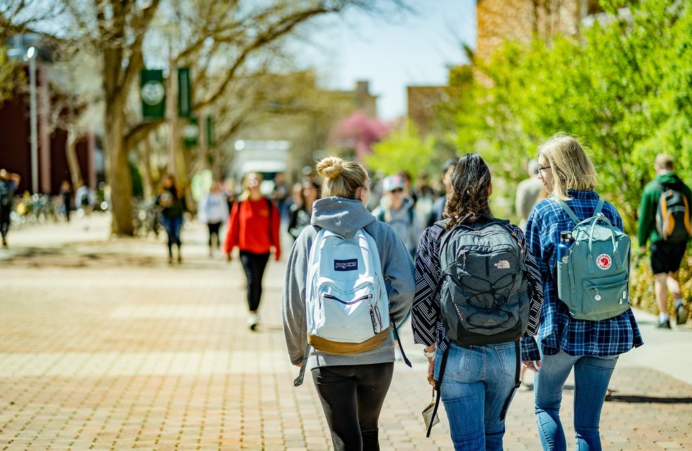 Students walking across a college campus