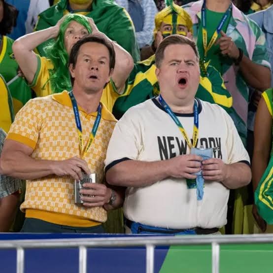Two lead characters reacting in the stands