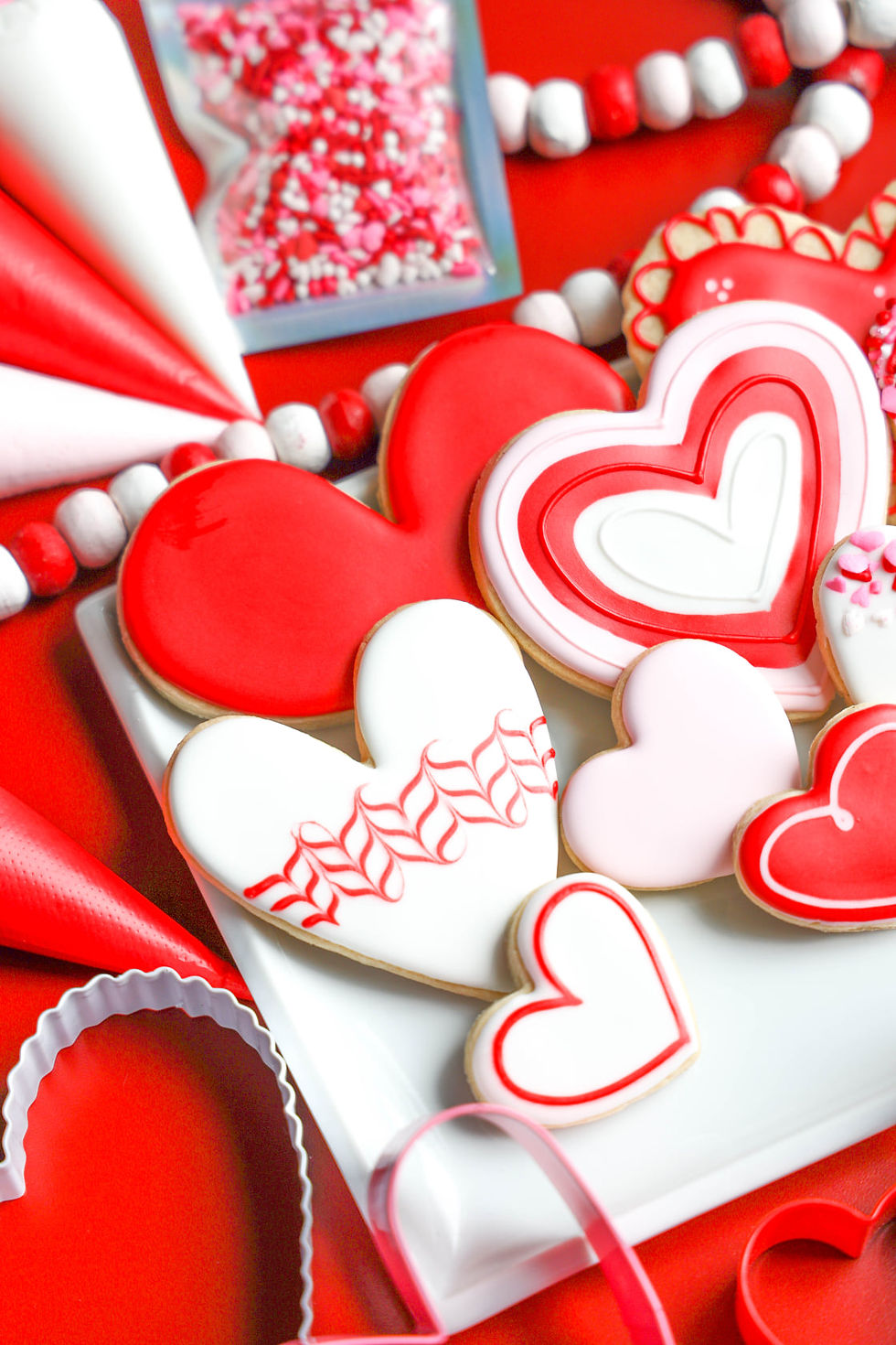 Thumbnail: A staged decorated example of the Valentine's Day Hearts Galore DIY cookie kit.  The kit includes 3 colors of royal icing and 6 heart shaped cookies.