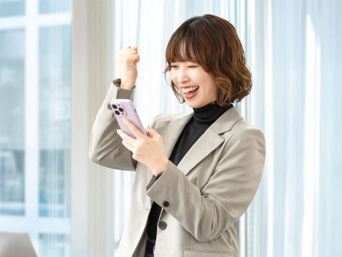 ガッツポーズをしながら配信を楽しむ女性