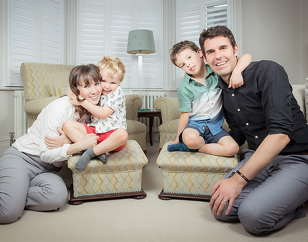 Family of four photographed together in their London home during an at-home family photoshoot.
