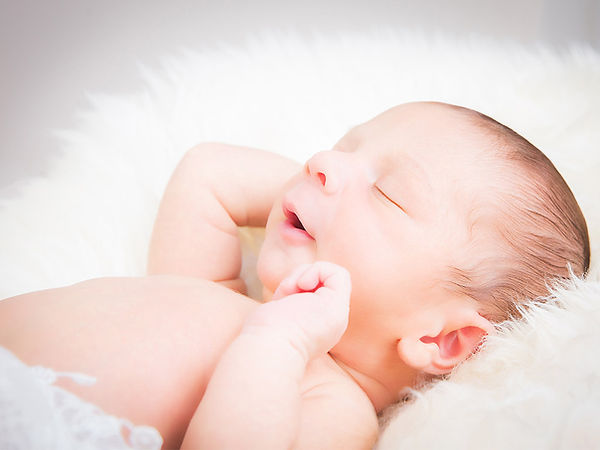 newborn photoshoot near me - close up of a baby in a white blanket