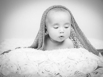 Sweet Dreams! Black & White Studio Portrait: Peaceful newborn nestled in a cozy wrap.