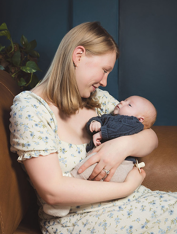 Mother holding newborn baby during a Pennypics newborn photoshoot in London