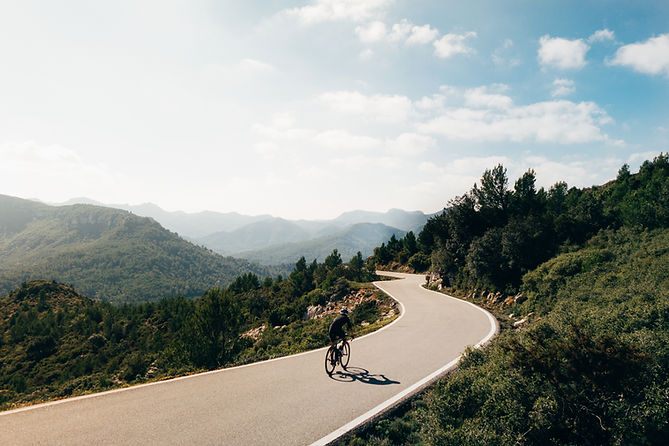 cyclist-riding-bike-sunset-mountain-roadoor.jpg