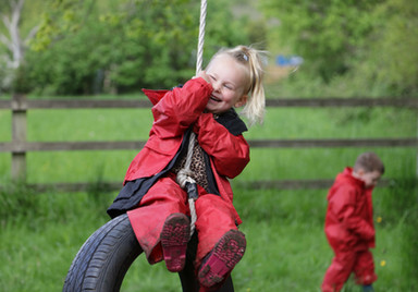 happy girl on tyre swing