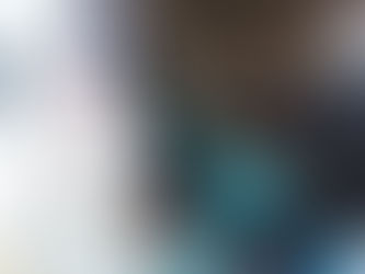 Boy creating moon shape from white pebbles