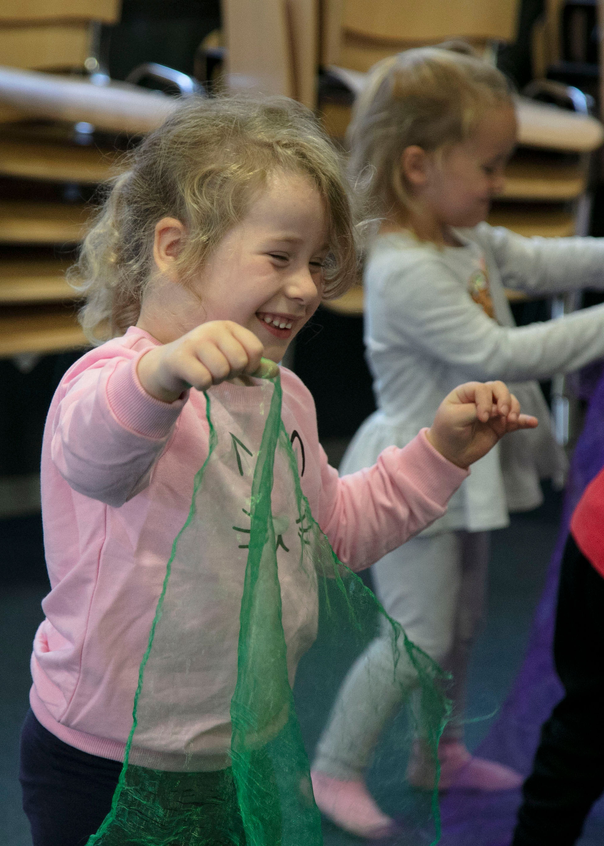girl laughs with green scarf